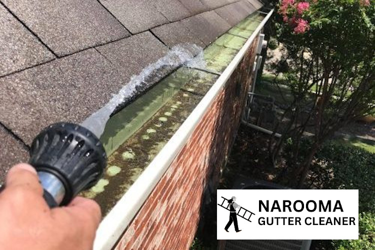 
Gutter cleaner using a hose for debris removal in Congo.